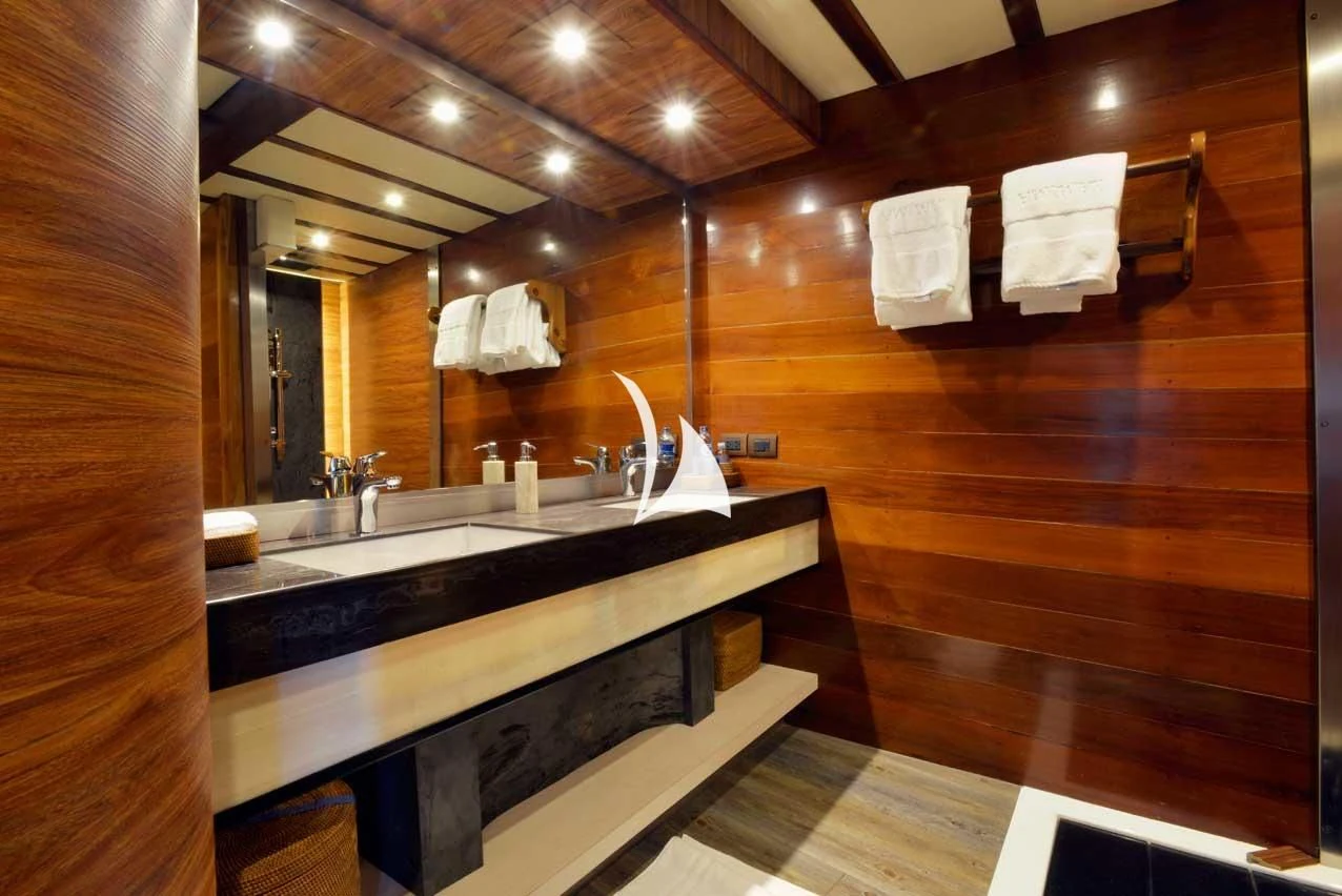 a bathroom with a countertop sink and a mirror aboard LAMIMA Yacht for Sale