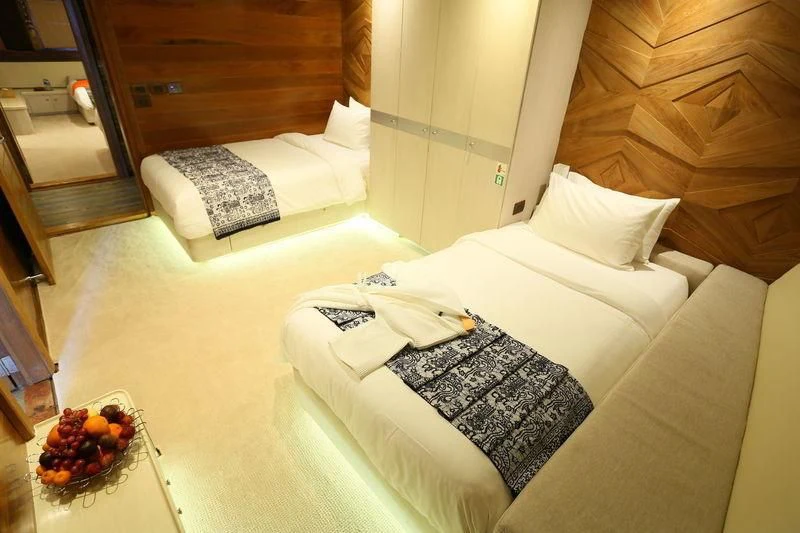 a bed with white pillows aboard LAMIMA Yacht for Sale