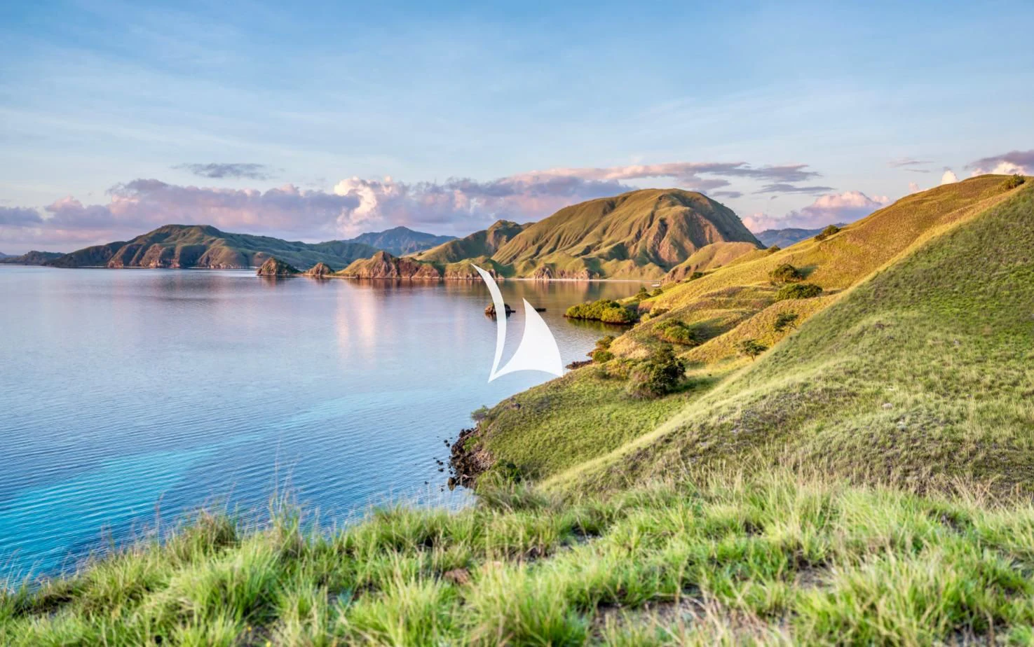 a body of water with grass and hills around it aboard LAMIMA Yacht for Sale