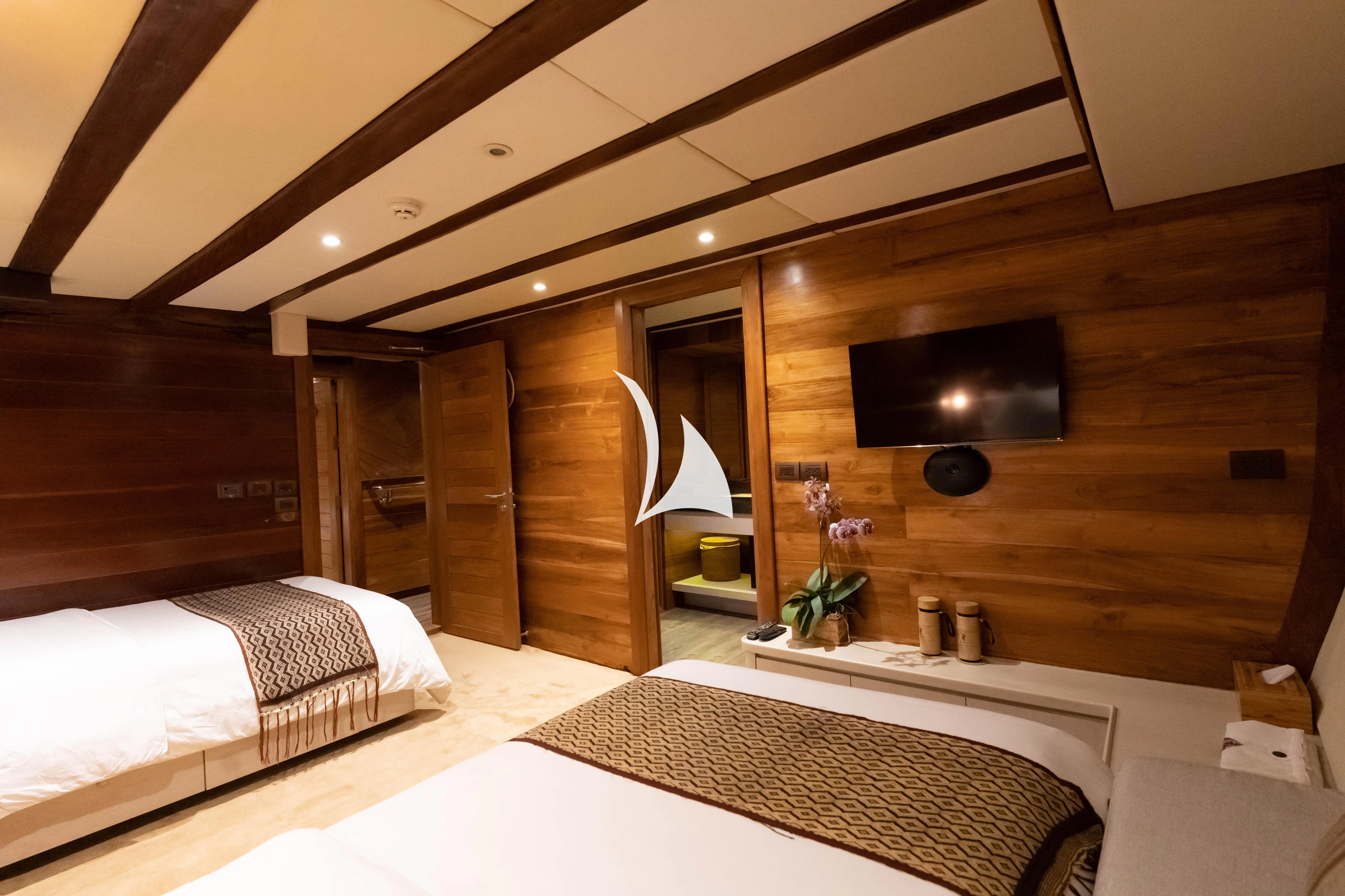 a room with two beds aboard LAMIMA Yacht for Sale