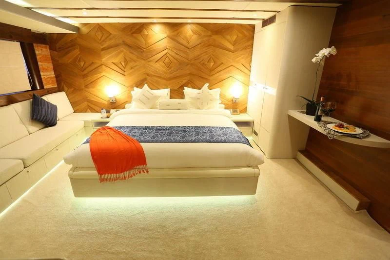a bed with a white bed aboard LAMIMA Yacht for Sale
