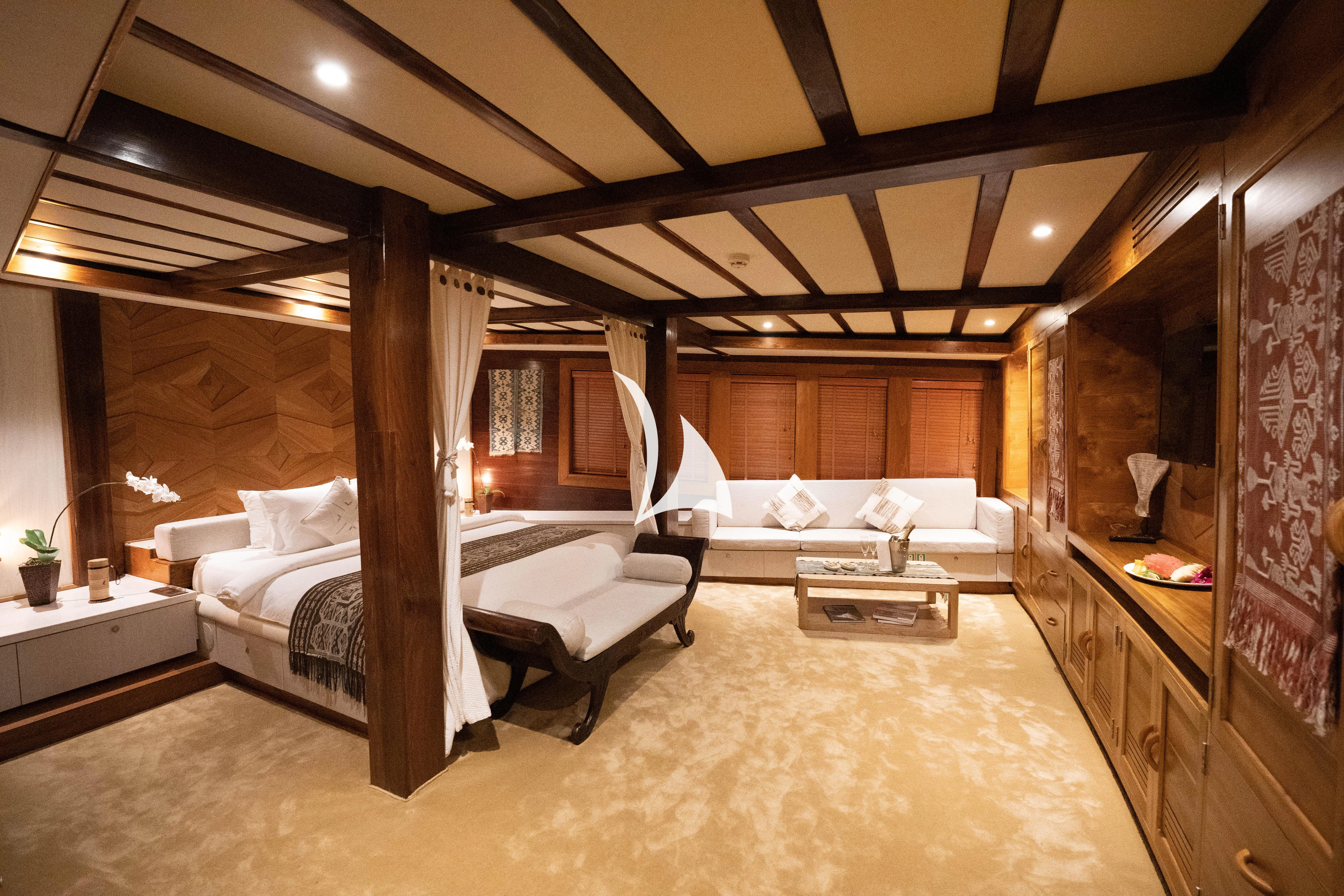 a room with a bed and a couch aboard LAMIMA Yacht for Sale