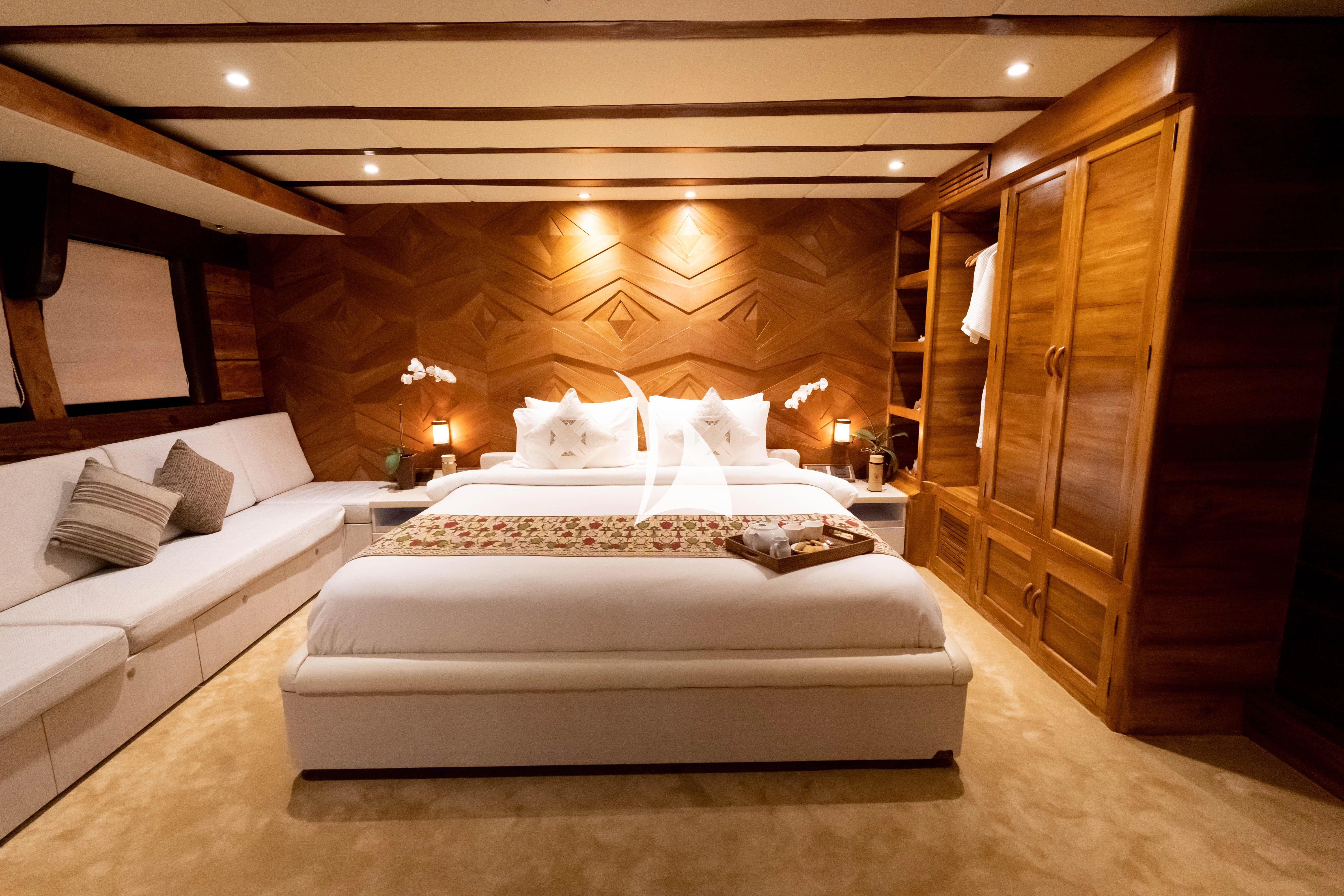 a bed with white sheets aboard LAMIMA Yacht for Sale