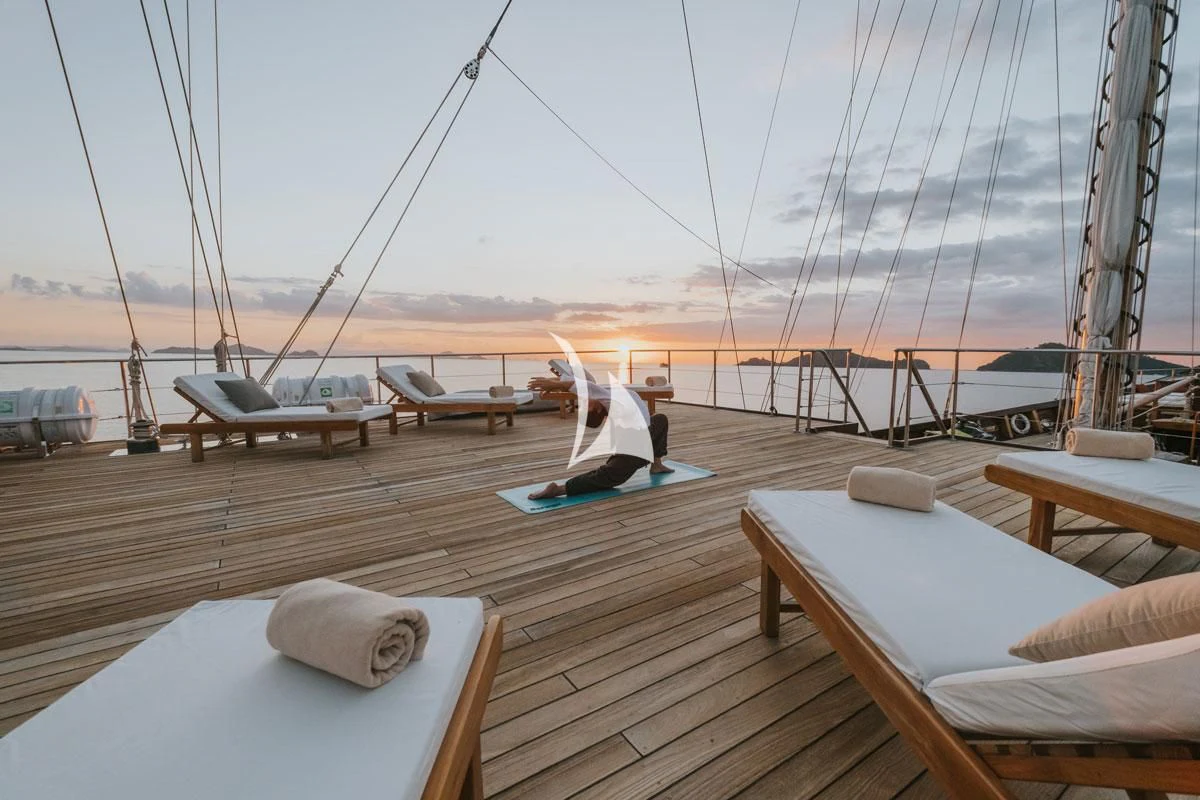 a deck with a boat on it and a person on a boat in the water aboard LAMIMA Yacht for Sale