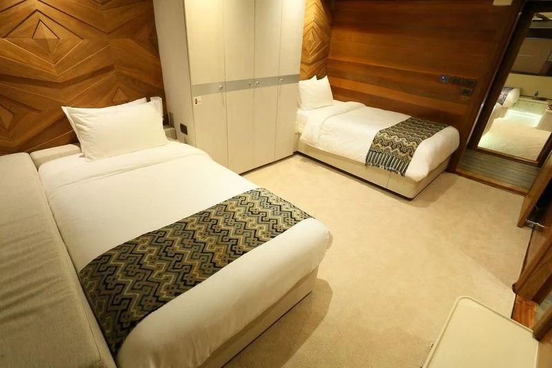 a room with a bed and a mirror aboard LAMIMA Yacht for Sale