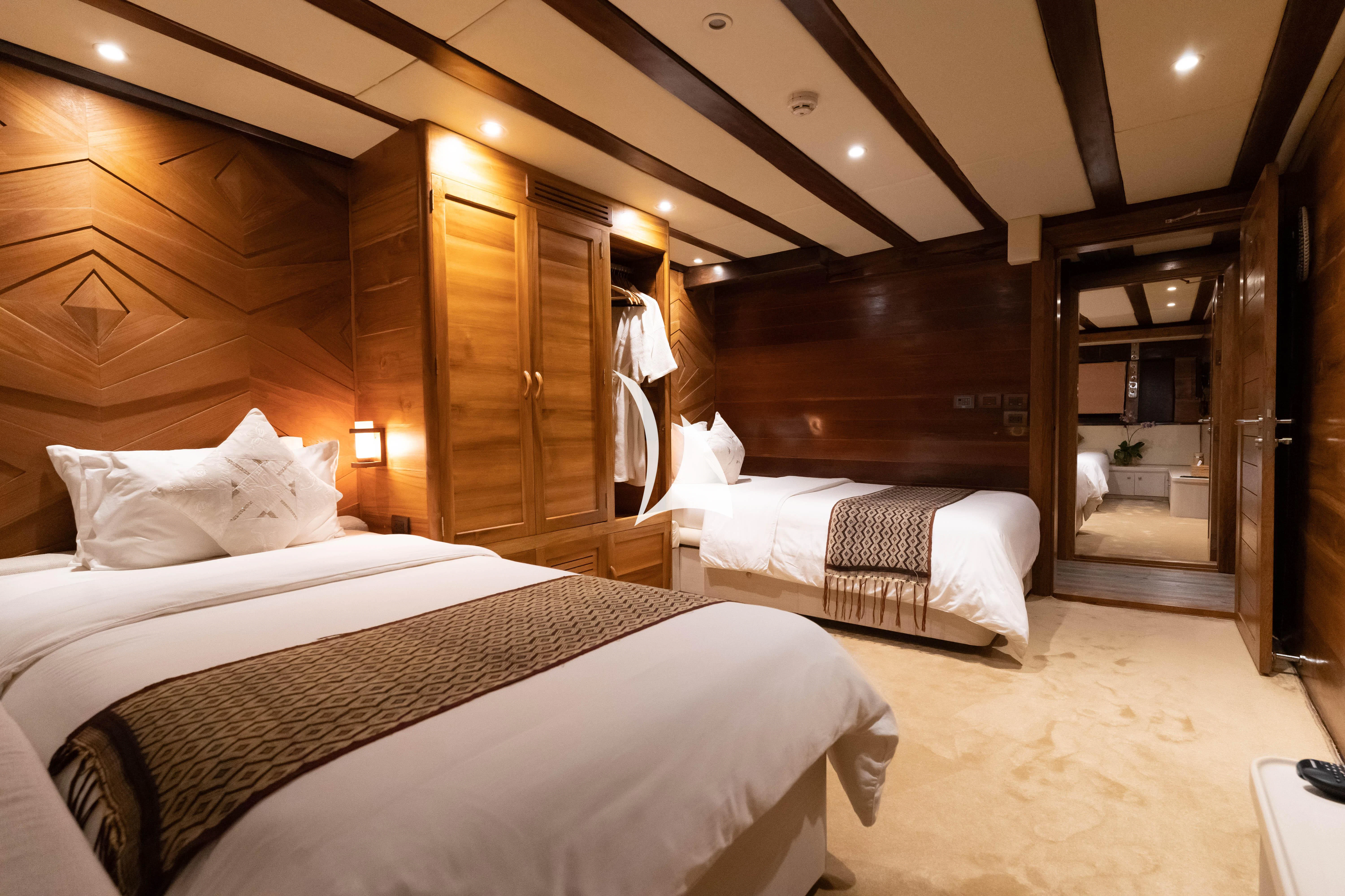a room with a couple of beds aboard LAMIMA Yacht for Sale