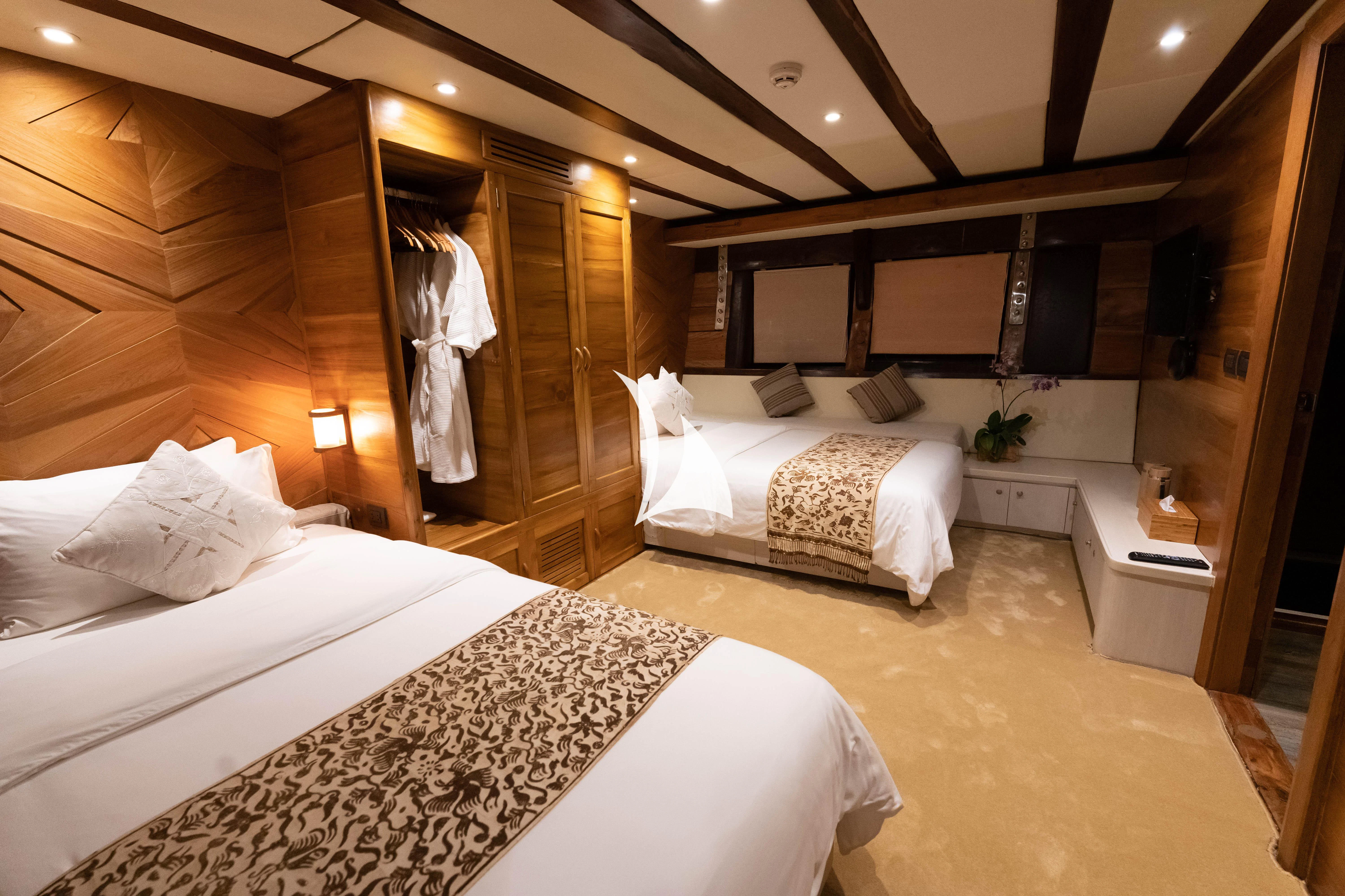 a room with a bed and a mirror aboard LAMIMA Yacht for Sale