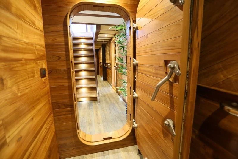 a wooden staircase with glass doors aboard LAMIMA Yacht for Sale