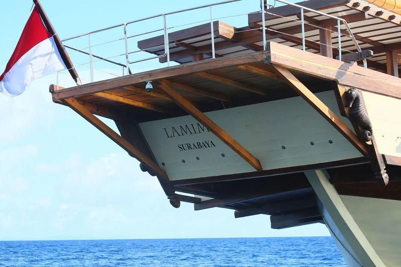 a boat with a flag on the front aboard LAMIMA Yacht for Sale