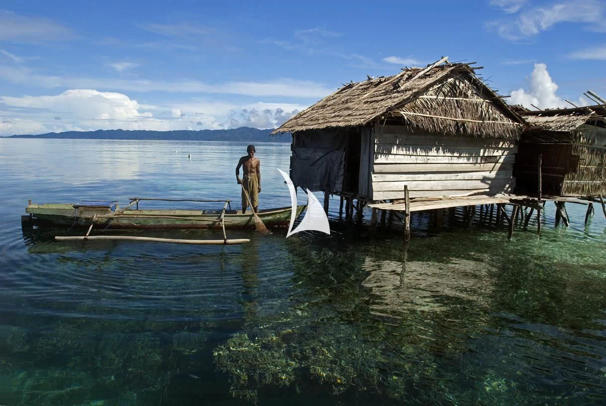 a couple of men standing on a dock in front of a house aboard LAMIMA Yacht for Sale