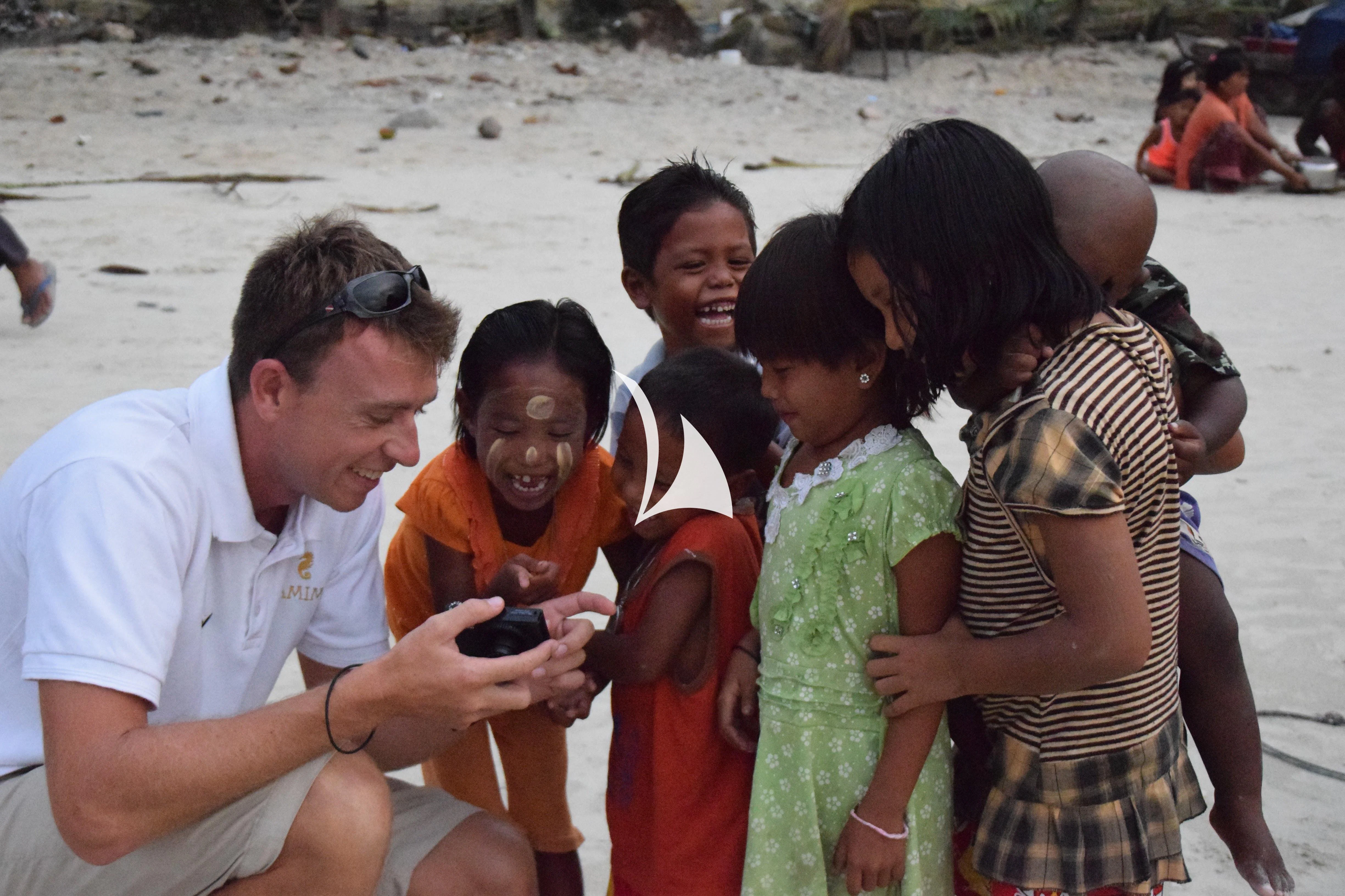 a group of people on a beach aboard LAMIMA Yacht for Sale