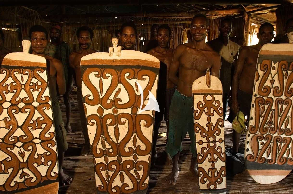 a group of men in a room with surfboards aboard LAMIMA Yacht for Sale