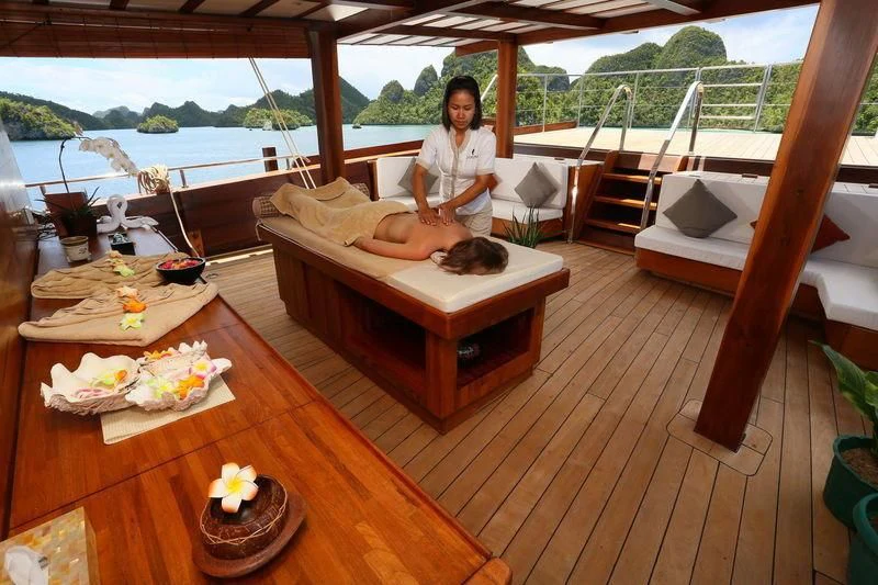a person sitting on a couch aboard LAMIMA Yacht for Sale