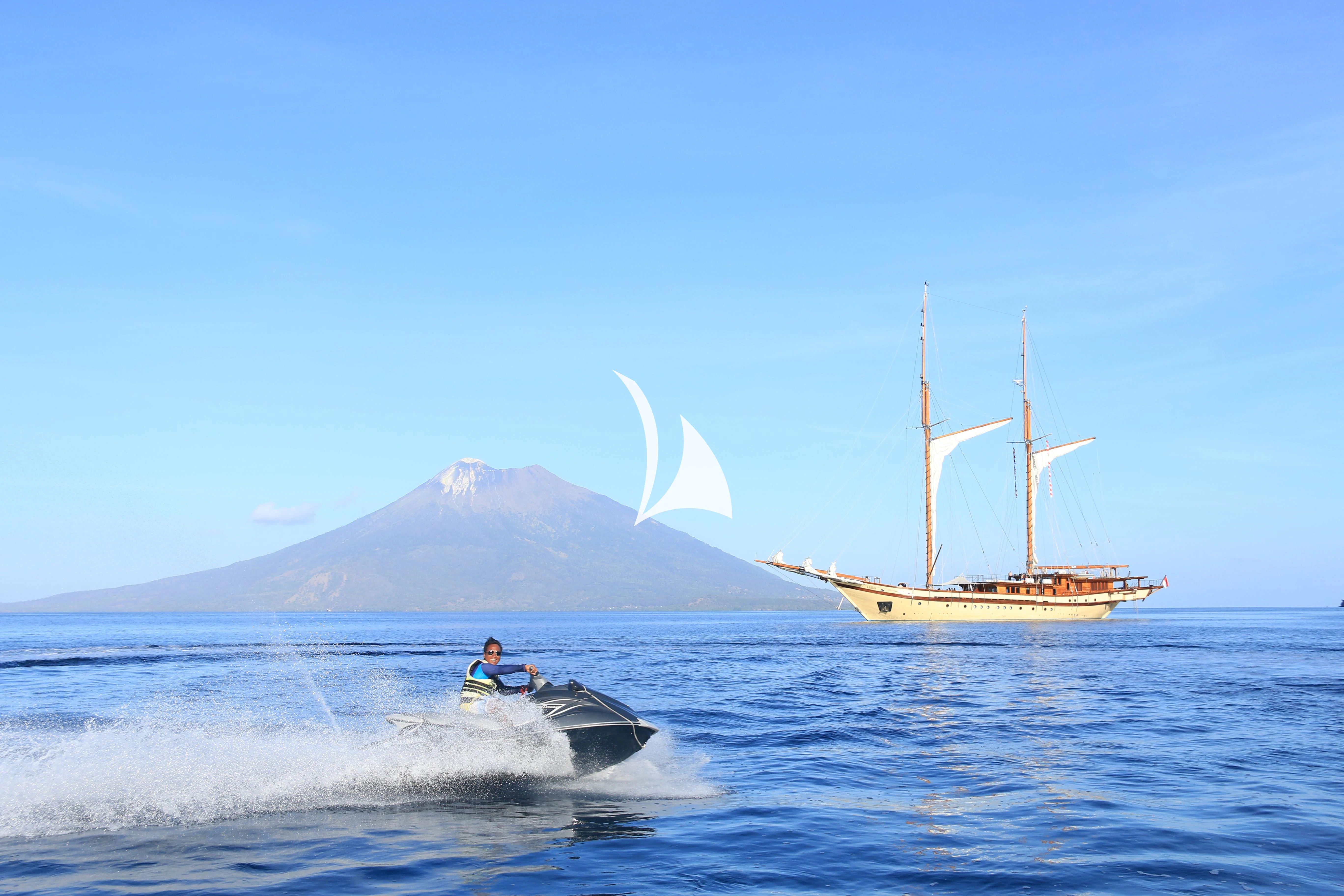 a sailboat in the water with a sailboat and a white crescent moon in the background aboard LAMIMA Yacht for Sale