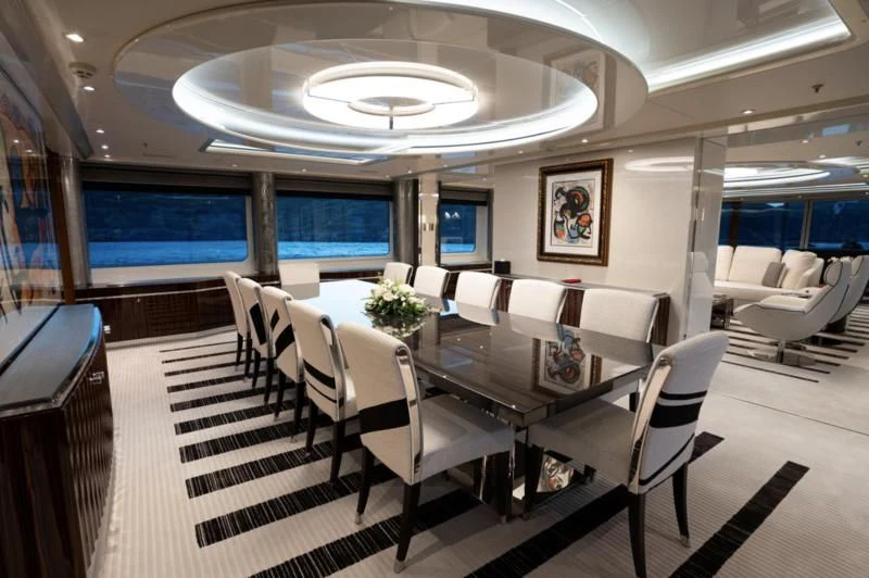 a room with a table and chairs aboard ALFA G Yacht for Sale