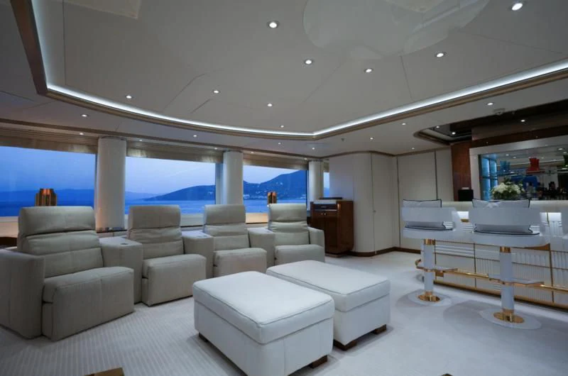 a room with a large white sofa and a large window aboard ALFA G Yacht for Sale