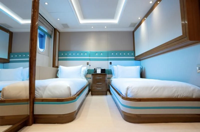 a room with a couple of beds aboard ALFA G Yacht for Sale