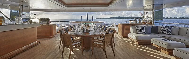 a room with a couch and a table and chairs aboard IJE Yacht for Sale