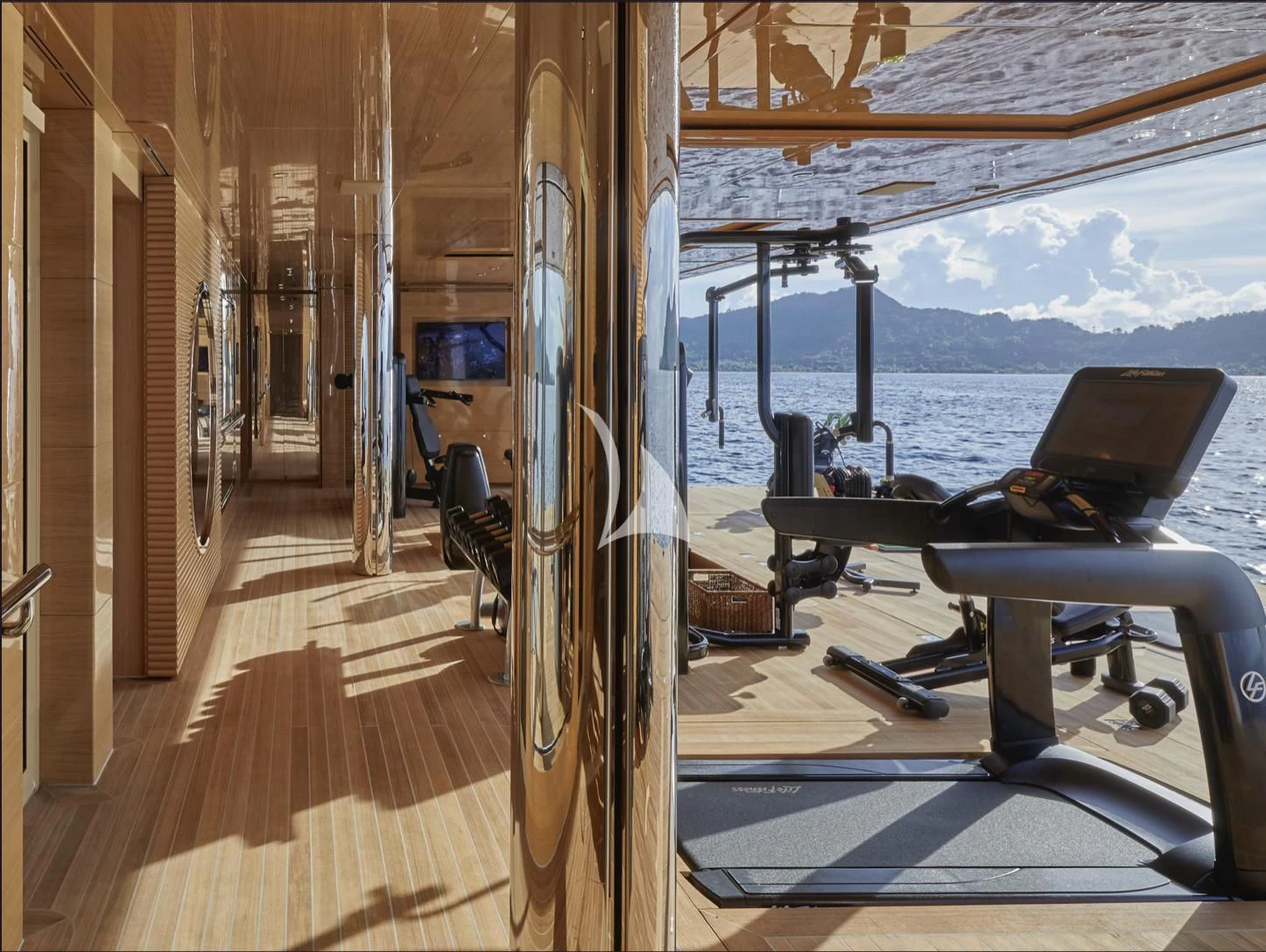 a deck with a large pool and a deck with a laptop on it aboard IJE Yacht for Sale