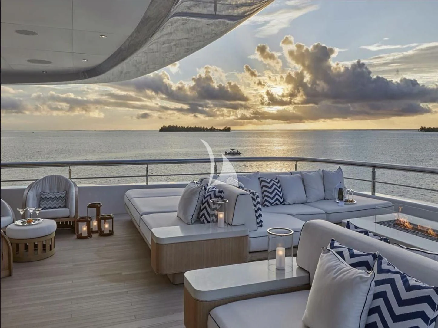 a room with a couch and a table and chairs on a deck aboard IJE Yacht for Sale
