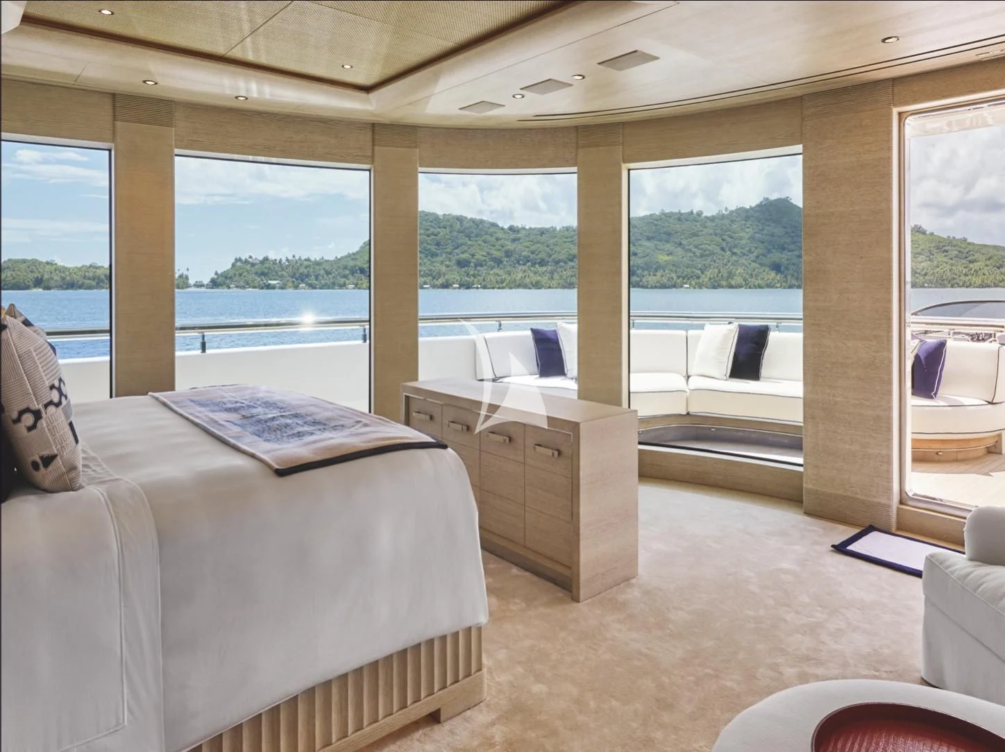 a room with a bed and a large window aboard IJE Yacht for Sale