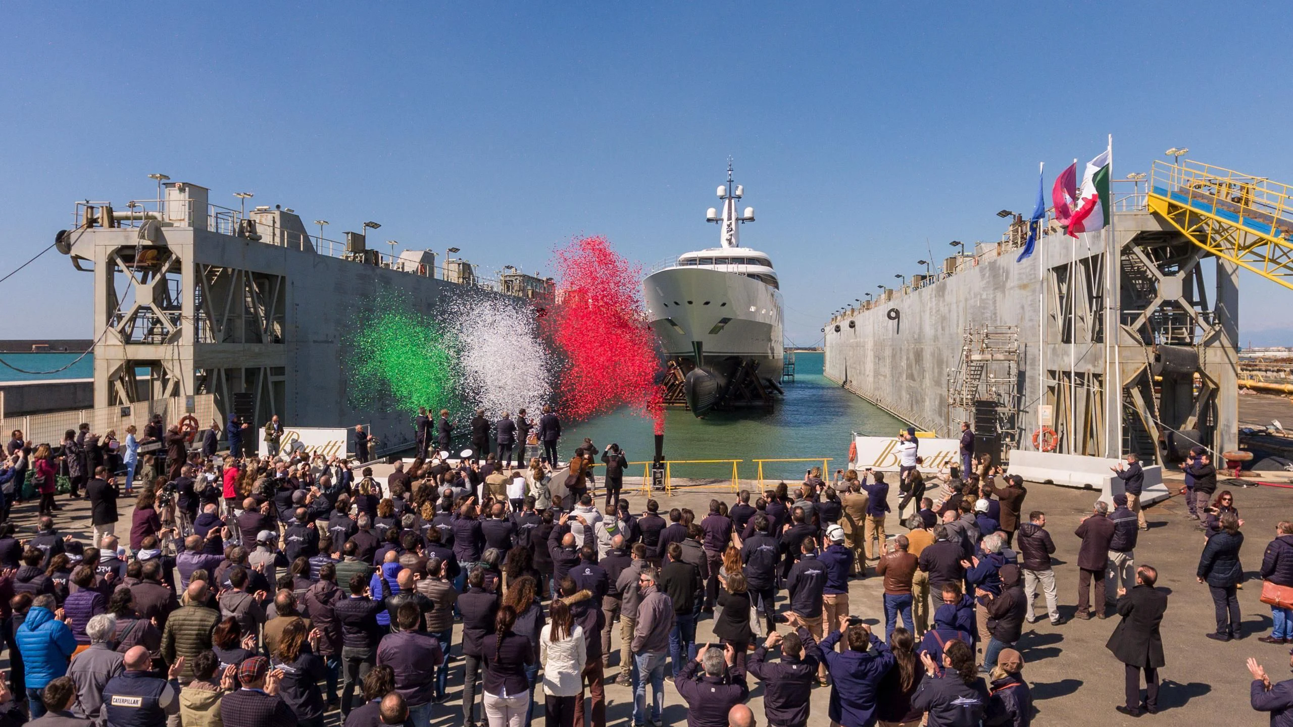 a crowd of people in front of a large ship aboard IJE Yacht for Sale