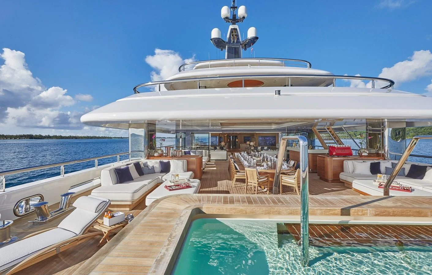 a large white cruise ship docked at a pier aboard IJE Yacht for Sale