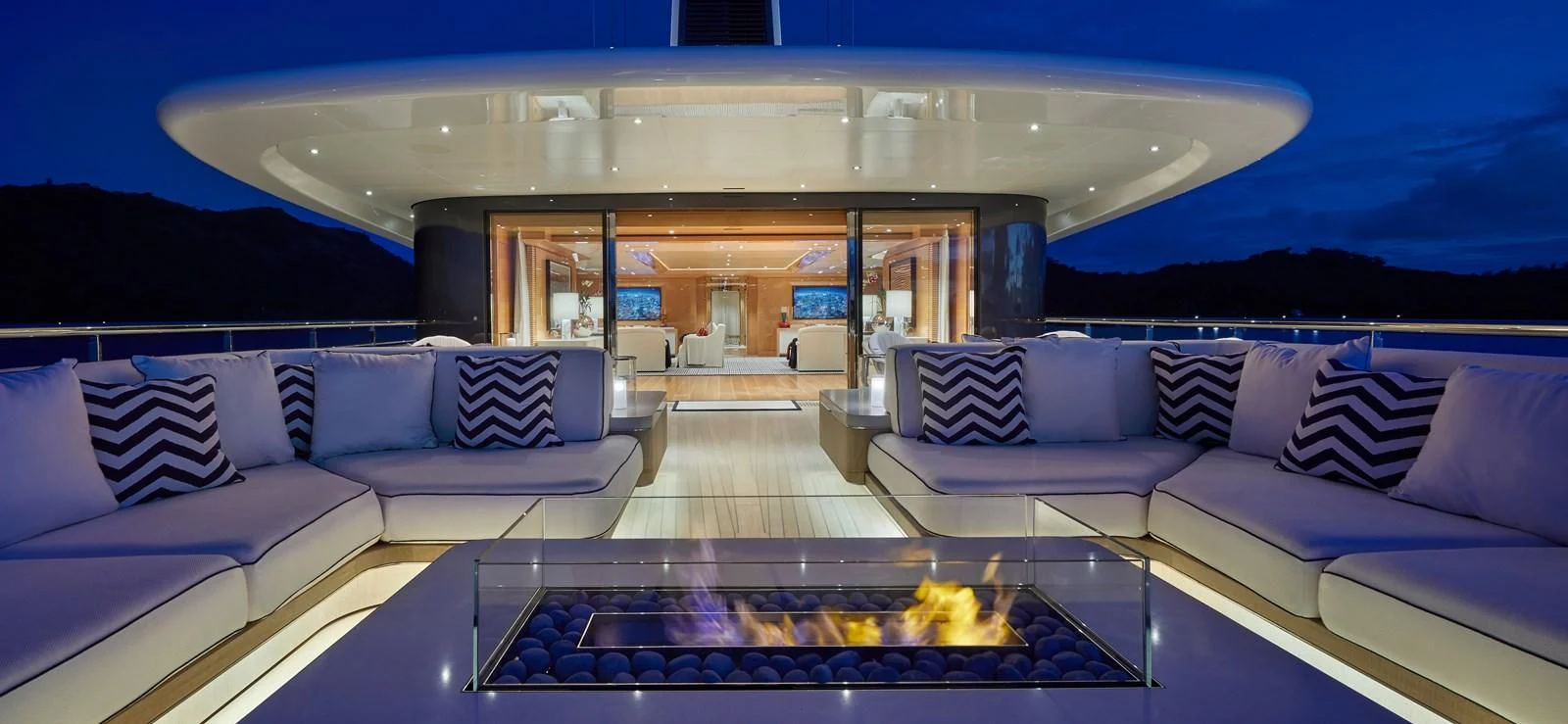 a living room with a large swimming pool aboard IJE Yacht for Sale