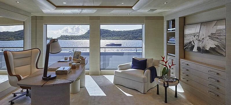 a living room with a couch and a table aboard IJE Yacht for Sale