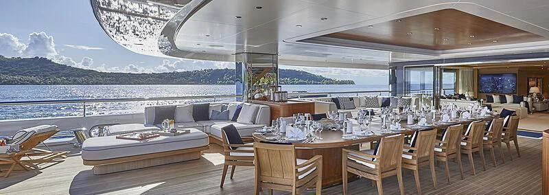 a room with a table and chairs aboard IJE Yacht for Sale