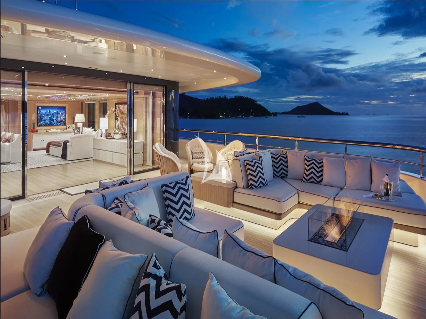 a modern living room with a large blue sky aboard IJE Yacht for Sale