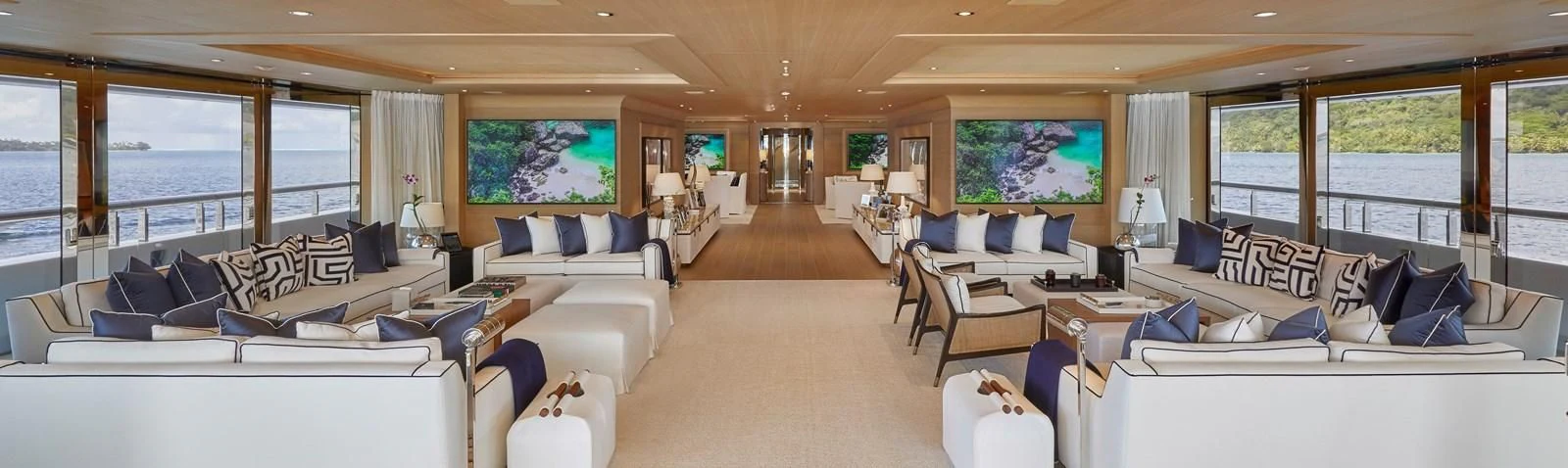 a living room with white furniture aboard IJE Yacht for Sale