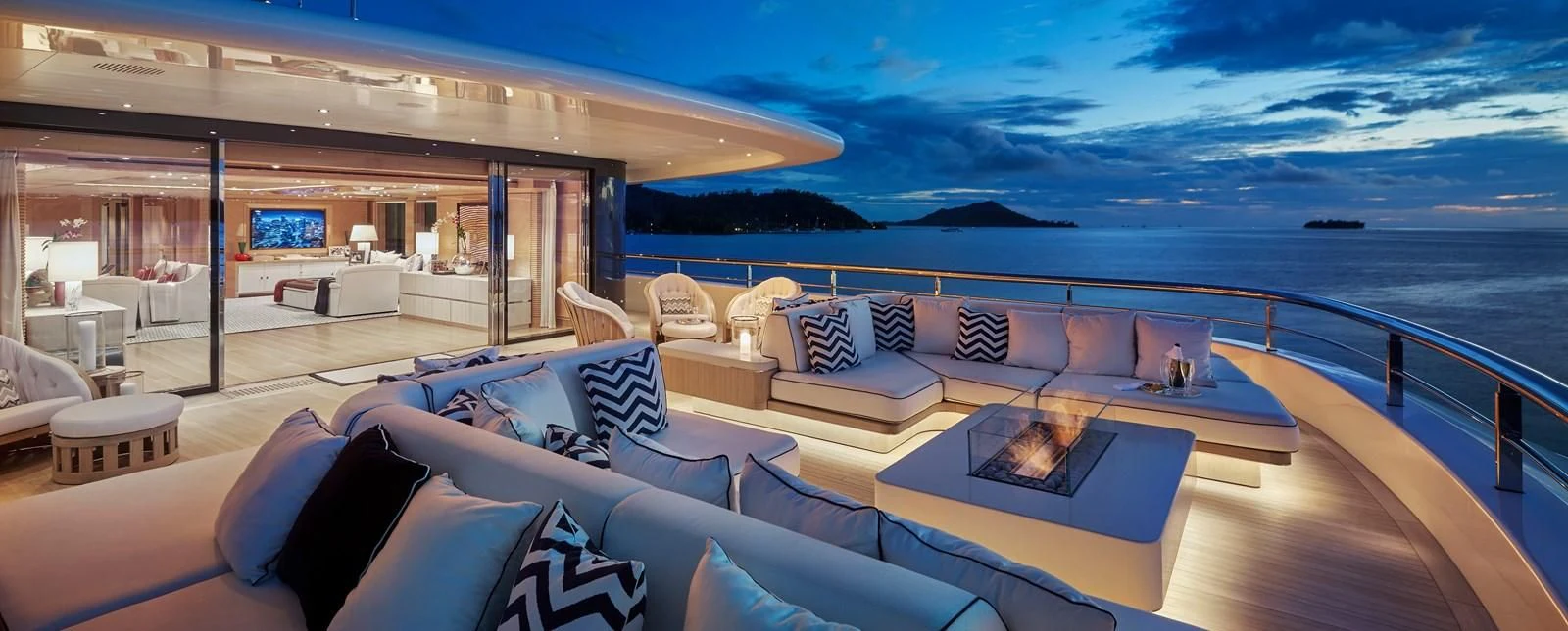 a large living room with a large swimming pool aboard IJE Yacht for Sale