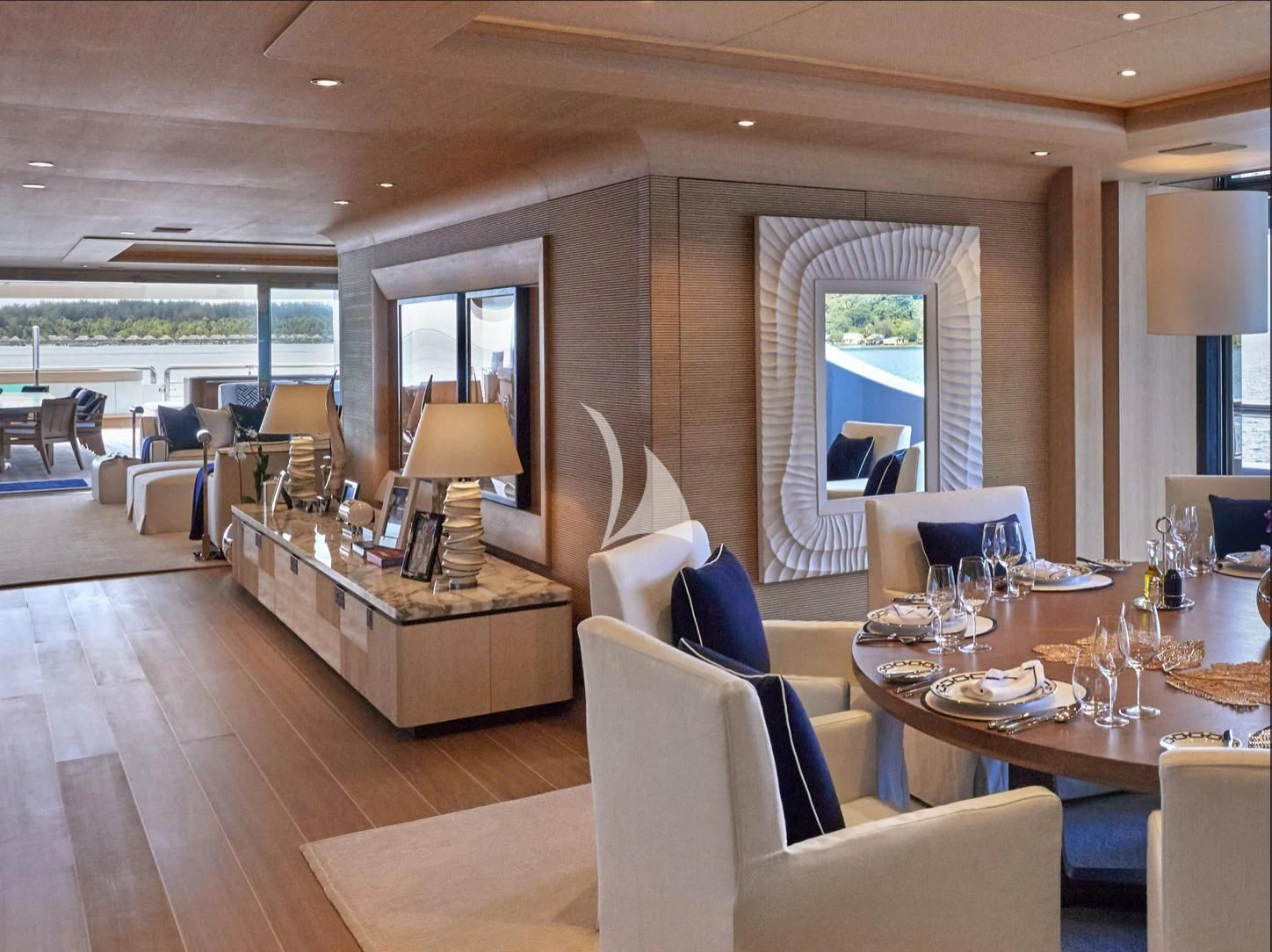 a living room with a large table and chairs aboard IJE Yacht for Sale