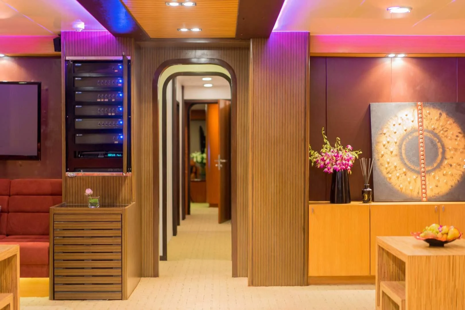 a room with a wall of cabinets and a vase with flowers aboard PHATSARA Yacht for Sale