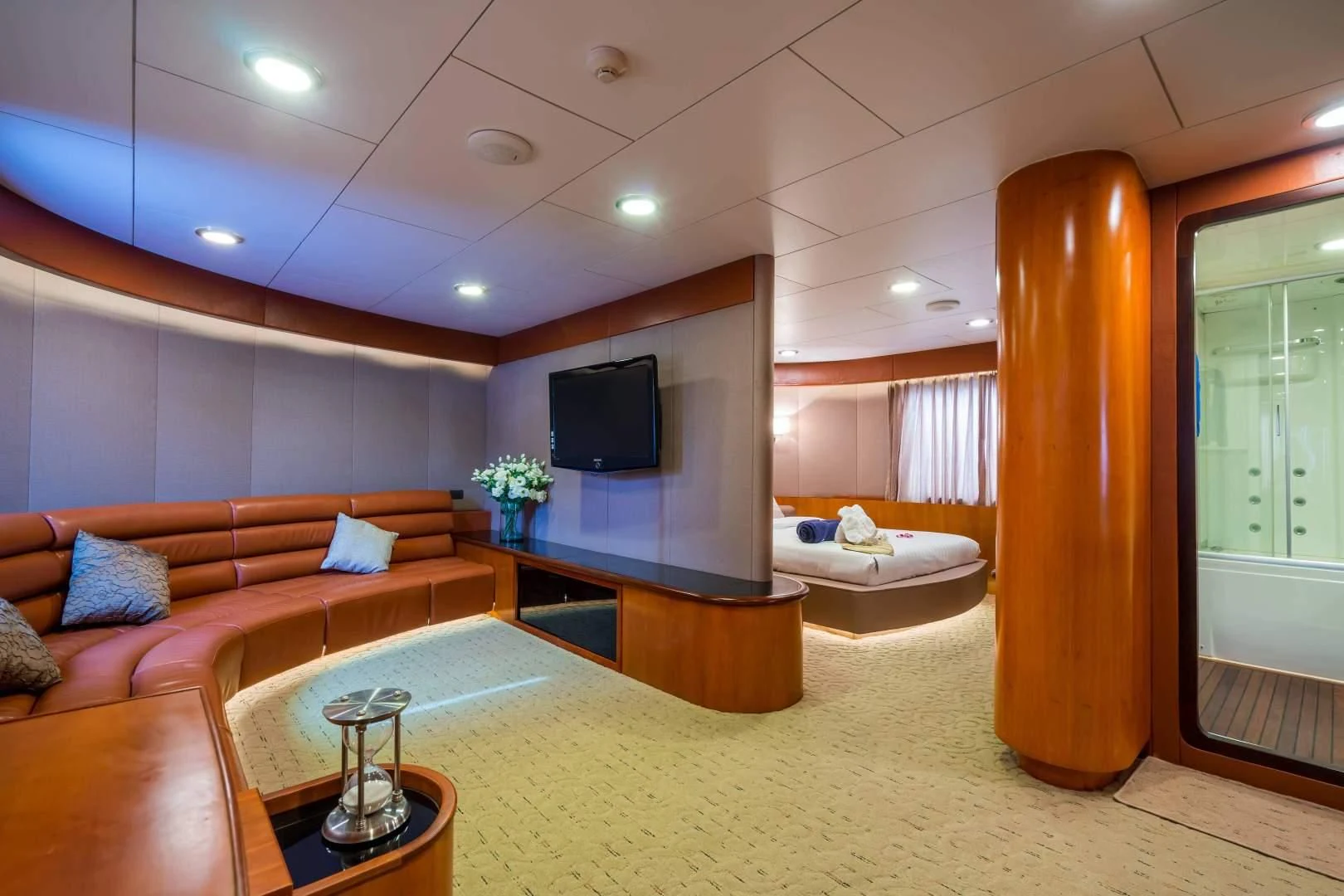 a living room with a large mirror aboard PHATSARA Yacht for Sale