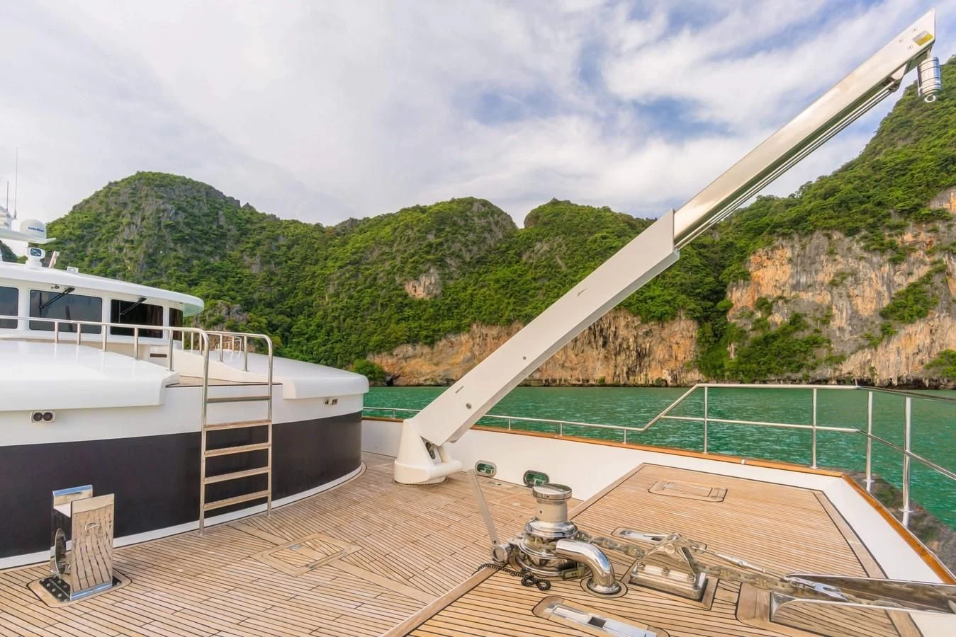 a deck with a railing and a boat on it aboard PHATSARA Yacht for Sale