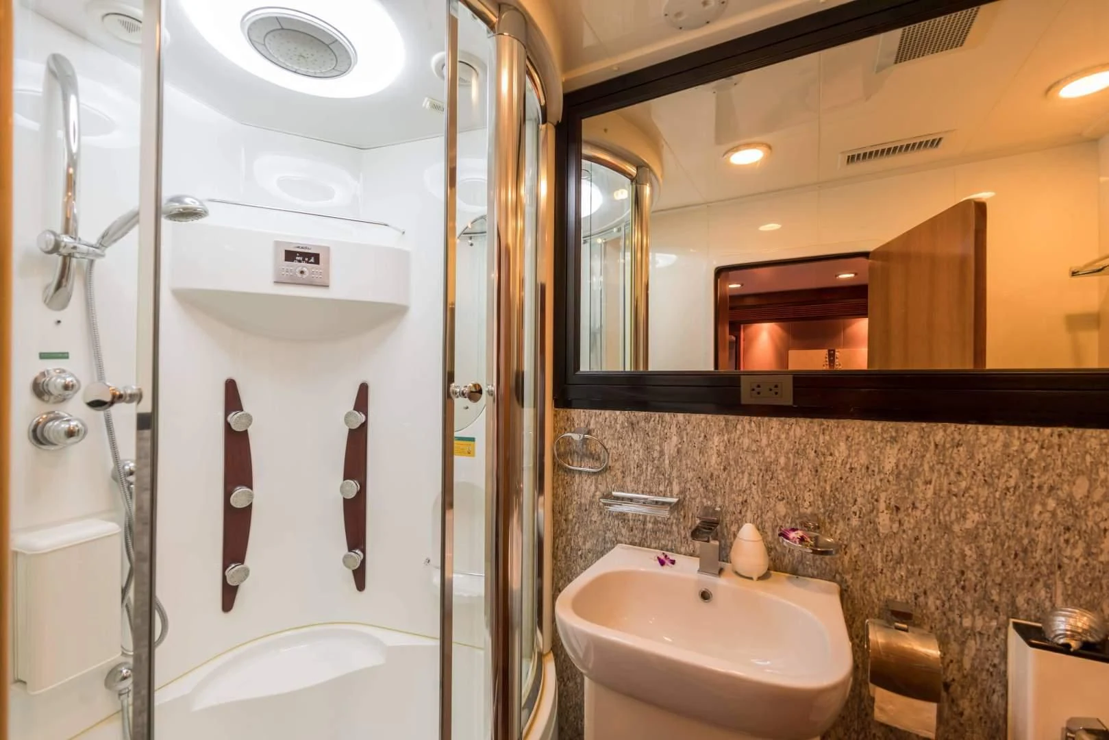 a bathroom with a large mirror aboard PHATSARA Yacht for Sale