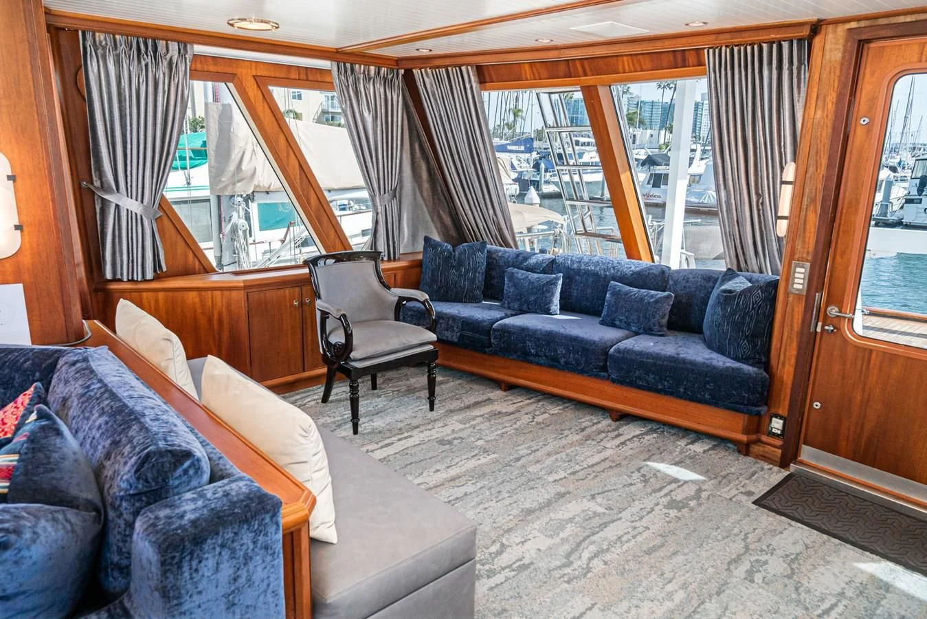 a living room with a couch and a window aboard NIRVANA Yacht for Sale