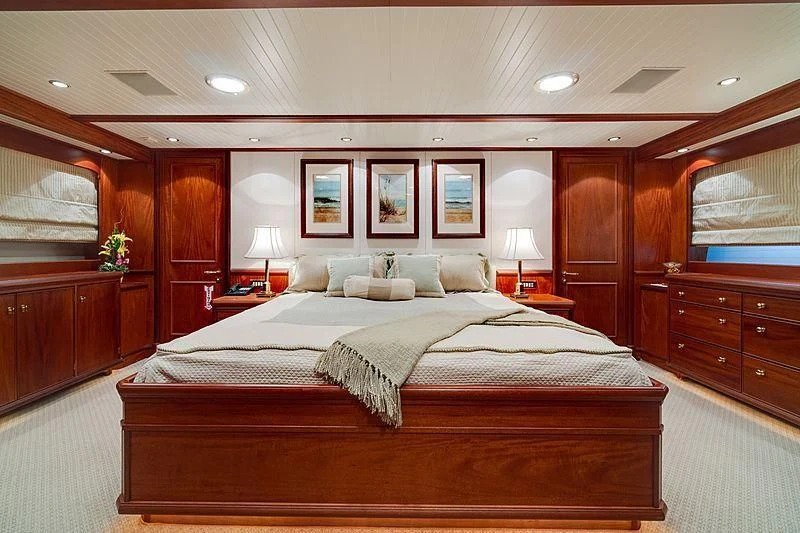 a bedroom with a bed and a desk aboard NIRVANA Yacht for Sale