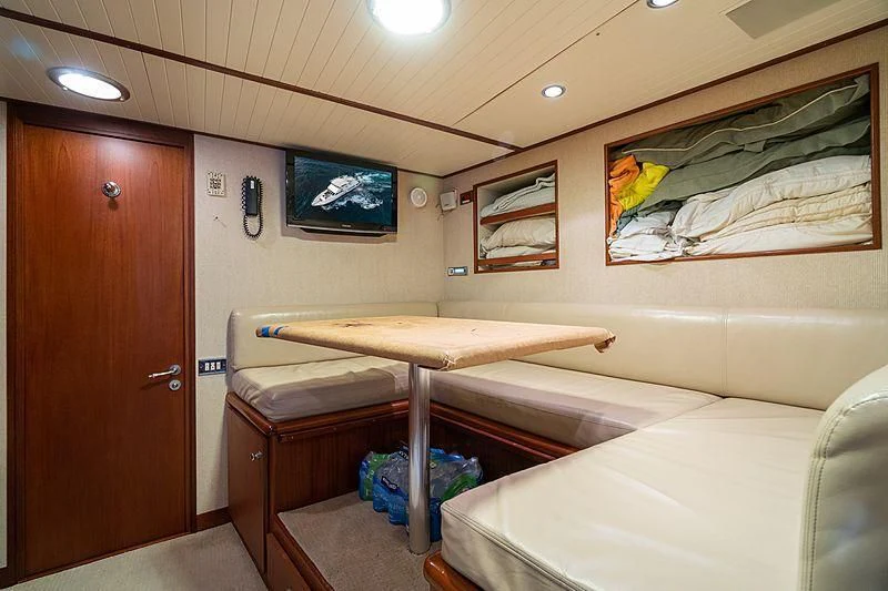 a room with a bed and a desk aboard NIRVANA Yacht for Sale