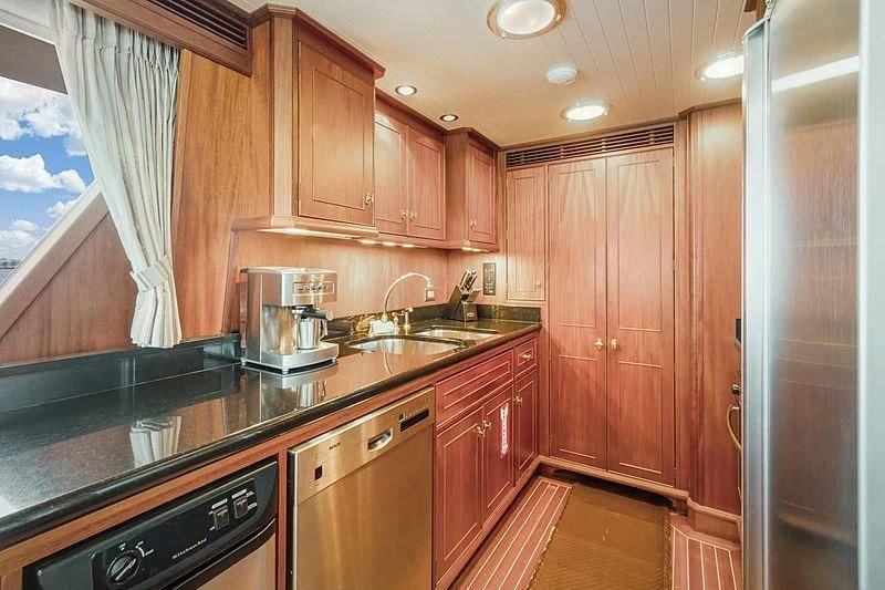 a kitchen with wooden cabinets aboard NIRVANA Yacht for Sale