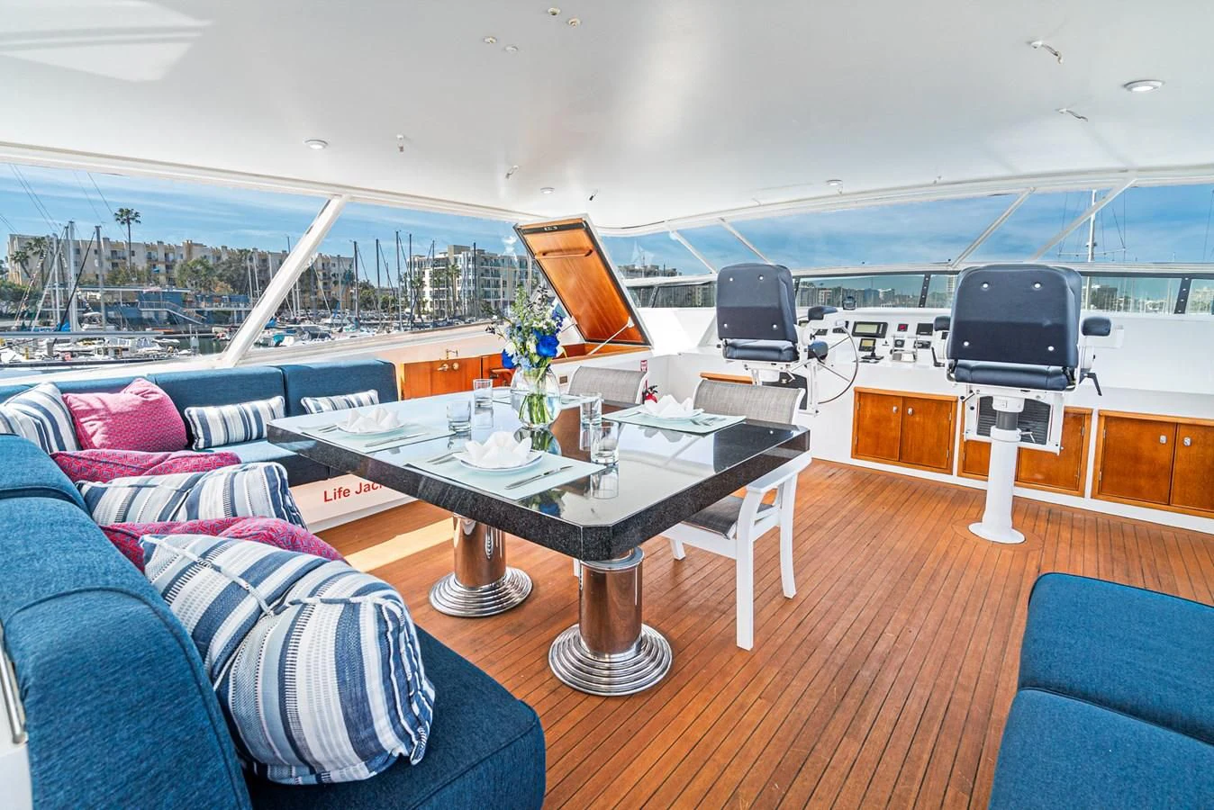 a living room with a table and tv aboard NIRVANA Yacht for Sale