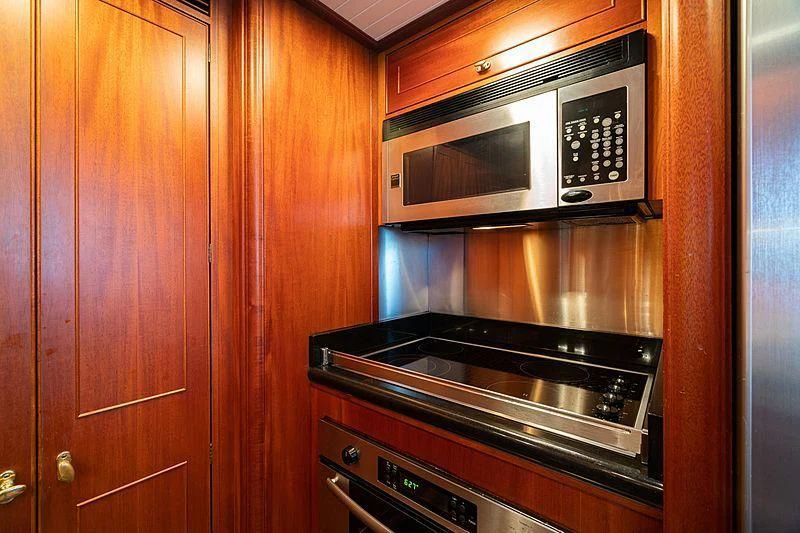 a kitchen with wooden cabinets aboard NIRVANA Yacht for Sale