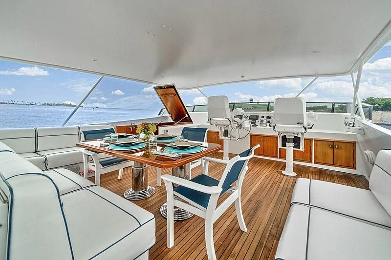 a room with a table chairs and a view of the ocean aboard NIRVANA Yacht for Sale