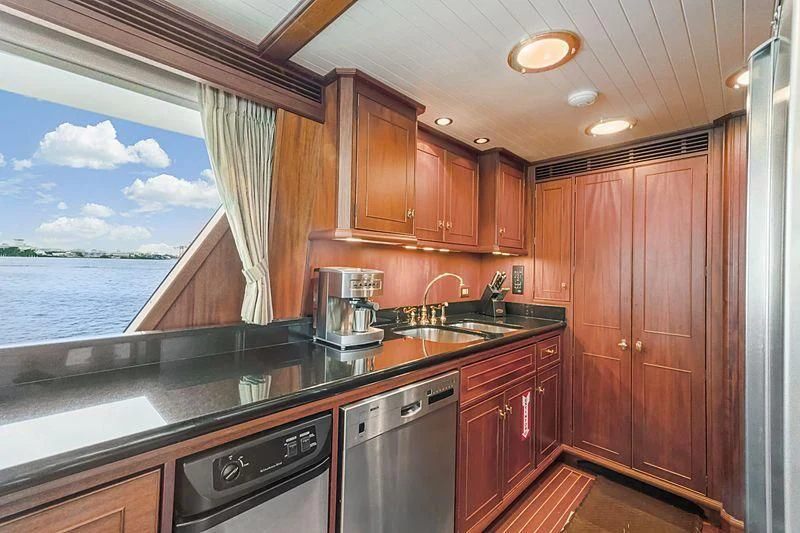 a kitchen with wooden cabinets aboard NIRVANA Yacht for Sale
