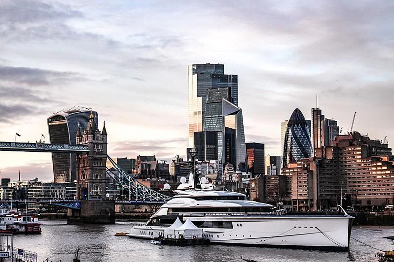 a boat in the water by a city aboard BRAVO EUGENIA Yacht for Sale