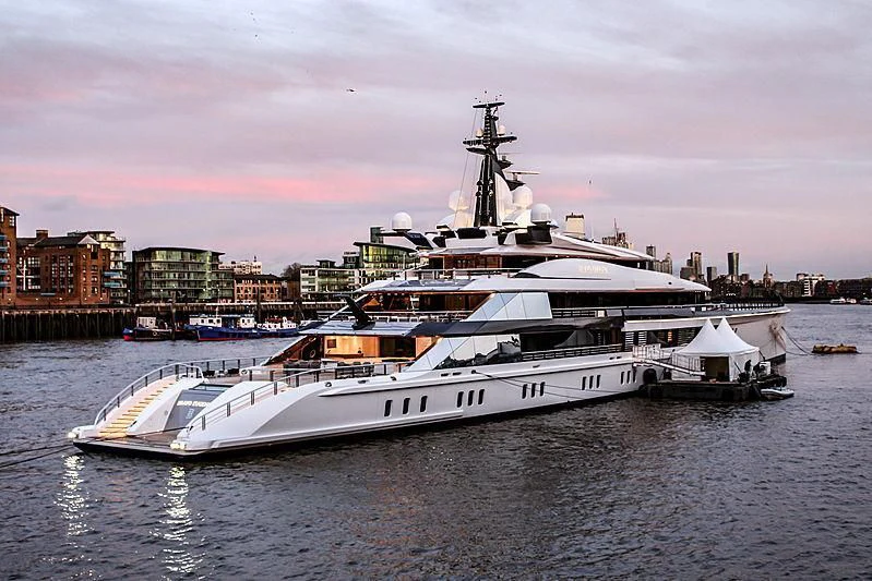 a large white boat in a harbor aboard BRAVO EUGENIA Yacht for Sale