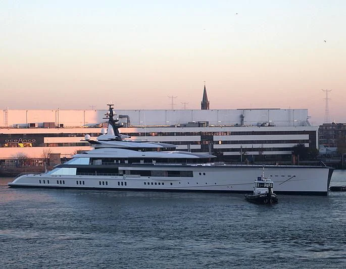 a large white boat in a harbor aboard BRAVO EUGENIA Yacht for Sale