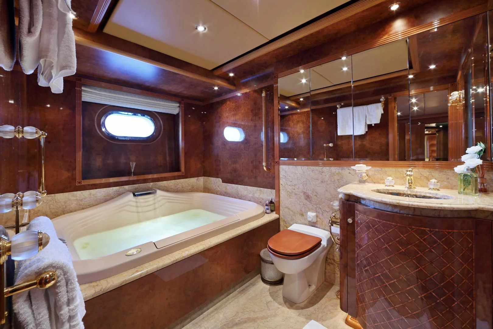 a bathroom with a tub sink and toilet aboard AQUA MARE Yacht for Sale